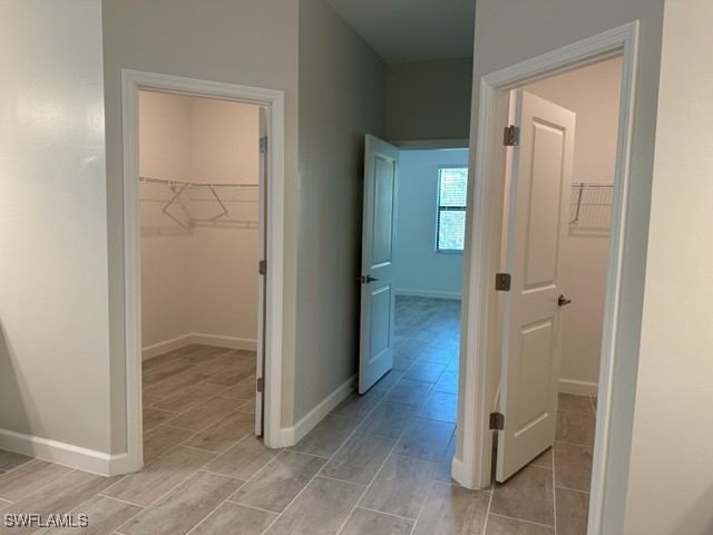 11156 Canopy Loop Fort Myers, FL 33913 - Photo 11 of 47 an empty room with wooden floor and mirror