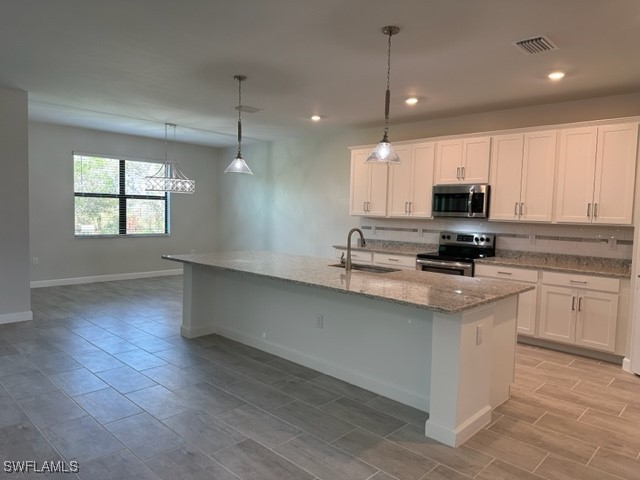 11156 Canopy Loop Fort Myers, FL 33913 - Photo 2 of 47 a kitchen with kitchen island white cabinets a sink a window and appliances