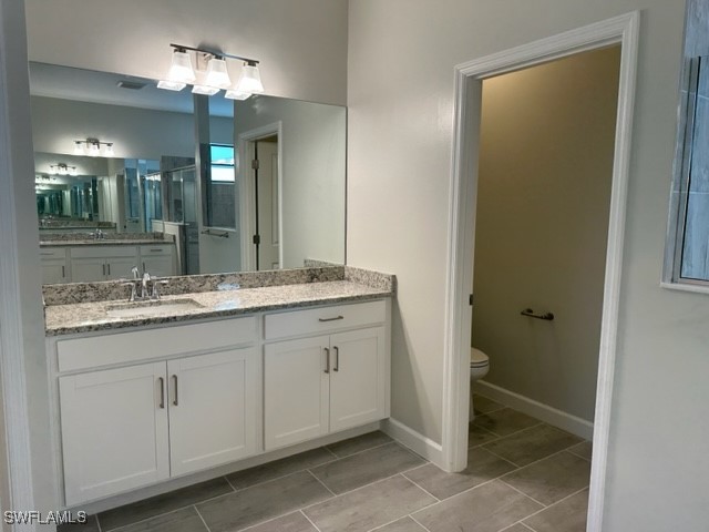 11156 Canopy Loop Fort Myers, FL 33913 - Photo 9 of 47 a bathroom with a double vanity sink and a mirror