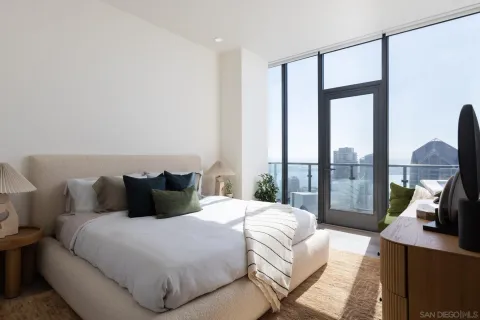 a bedroom with a large bed and a large window