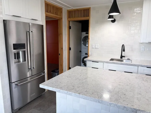 a kitchen with stainless steel appliances kitchen island a refrigerator sink and stove