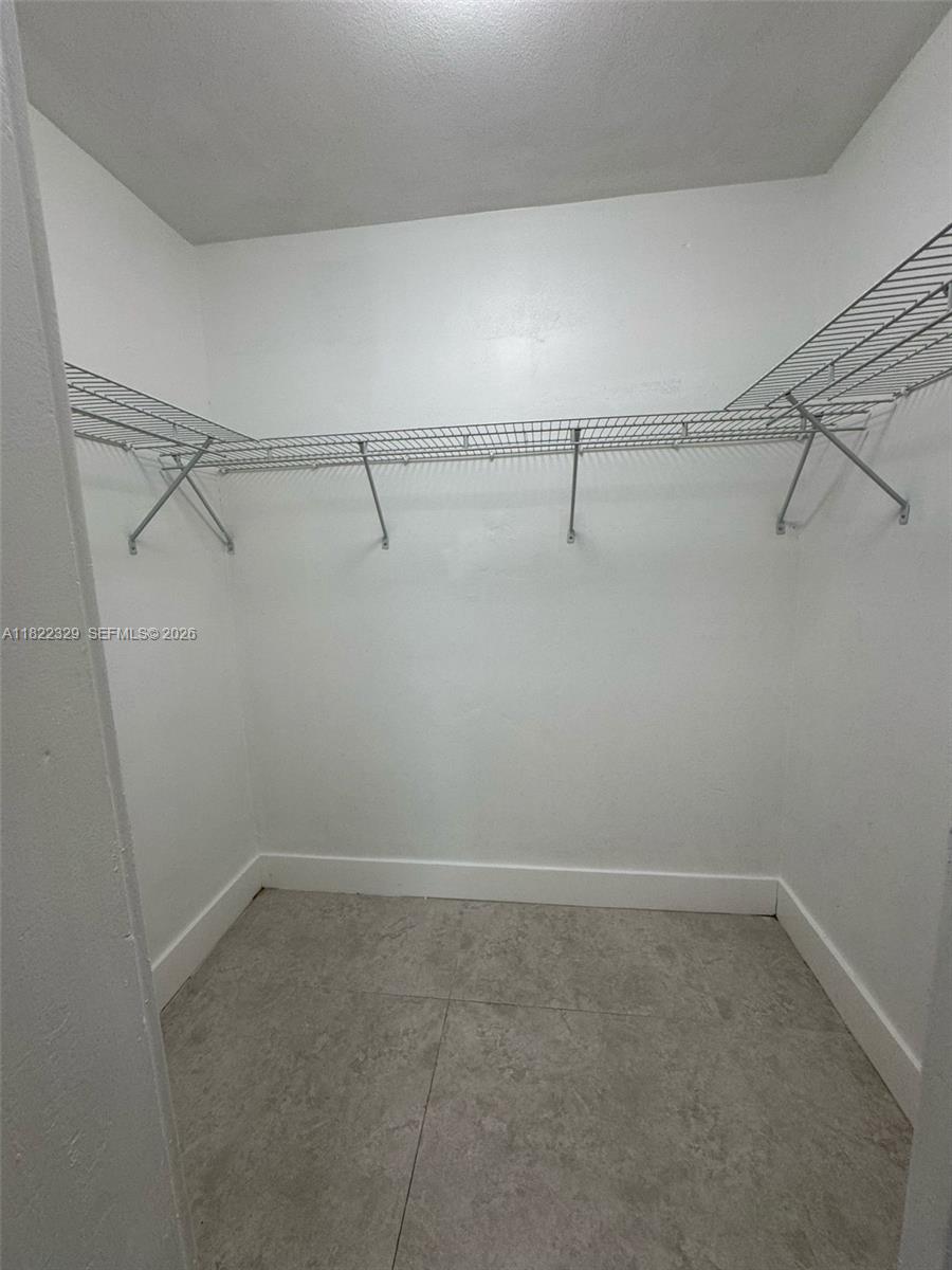 2941 Southwest 36th Avenue, Unit A Miami, FL 33133 - Photo 12 of 21 a view of a room with racks on the wall