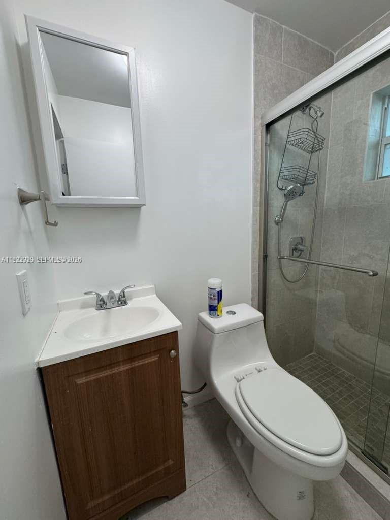 2941 Southwest 36th Avenue, Unit A Miami, FL 33133 - Photo 13 of 21 a bathroom with a toilet sink and shower