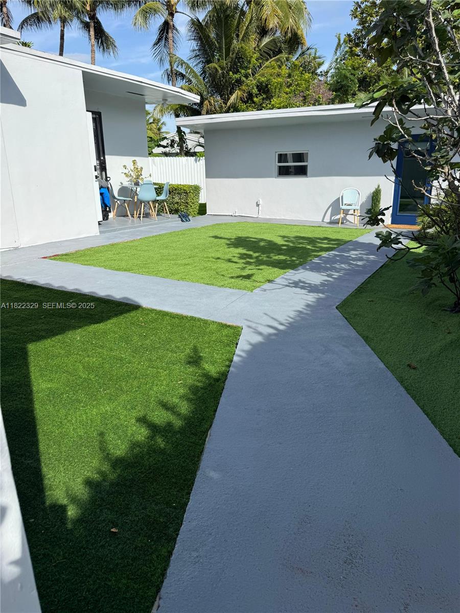 2941 Southwest 36th Avenue, Unit A Miami, FL 33133 - Photo 17 of 23 a front view of a house with a yard and garage