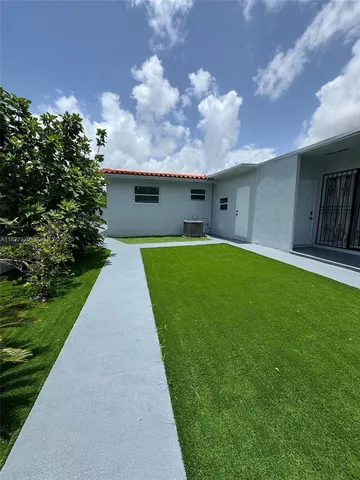 a backyard of a house with a garden and yard