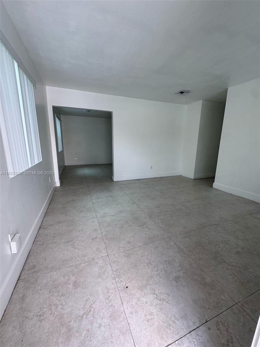 2941 Southwest 36th Avenue, Unit A Miami, FL 33133 - Photo 2 of 23 an empty room with windows