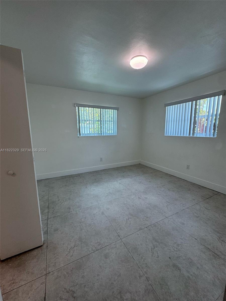 2941 Southwest 36th Avenue, Unit A Miami, FL 33133 - Photo 4 of 23 an empty room with windows