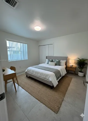 a bedroom with bed and a window