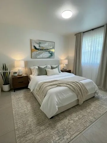 a bedroom with a bed and window