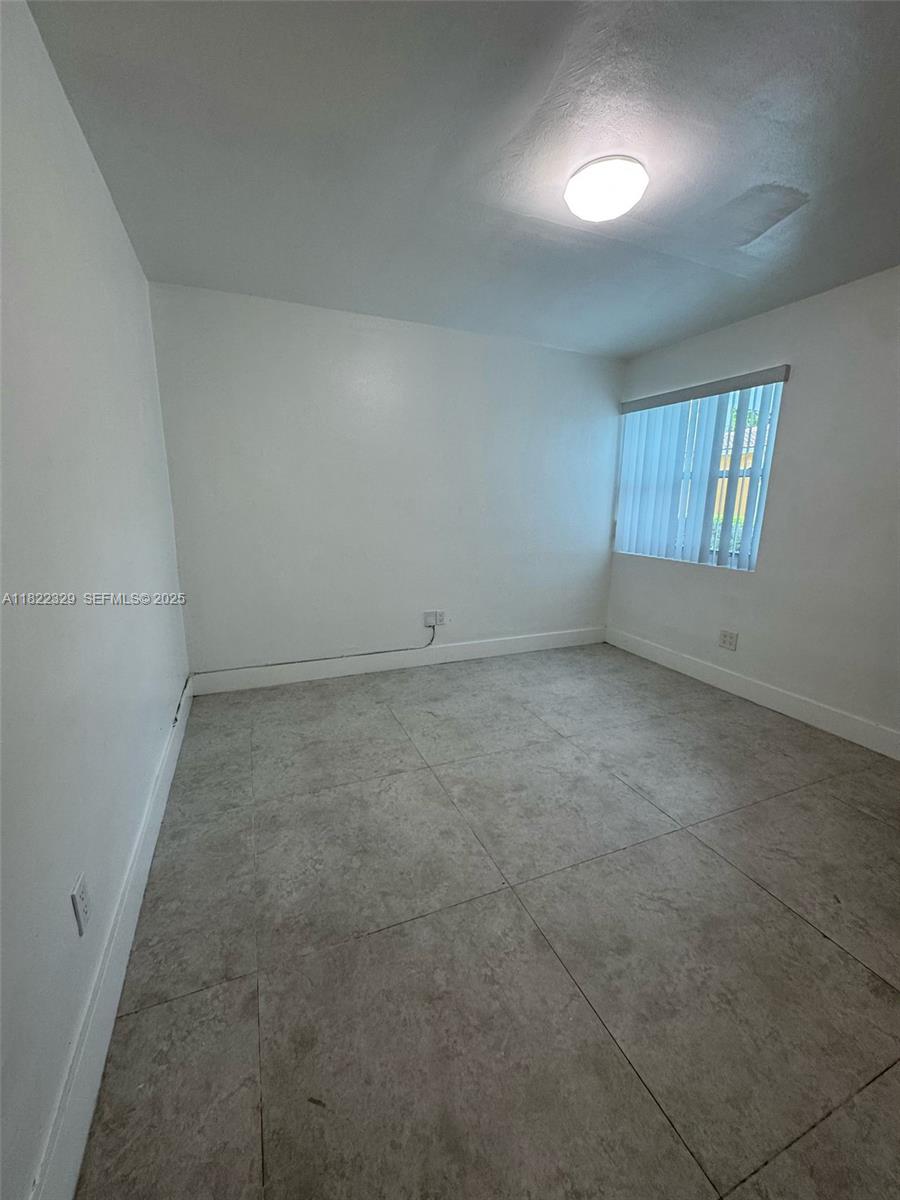 2941 Southwest 36th Avenue, Unit A Miami, FL 33133 - Photo 10 of 23 an empty room with a window