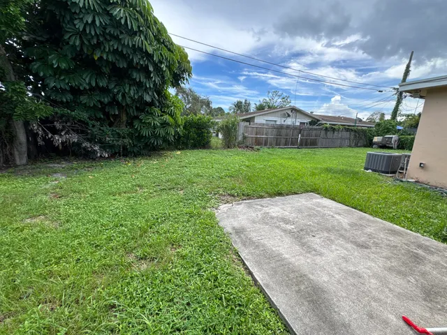 a view of a garden with a house