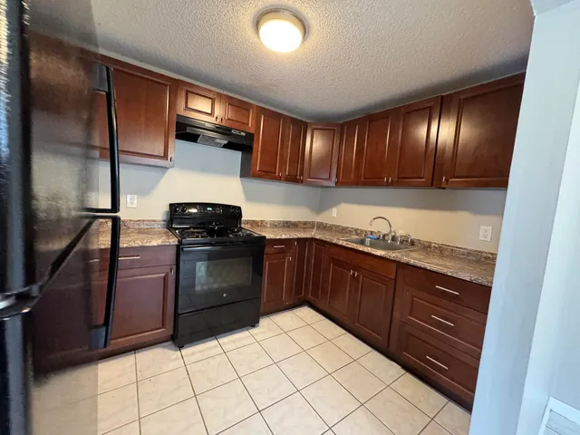 a kitchen with granite countertop cabinets and steel stainless steel appliances