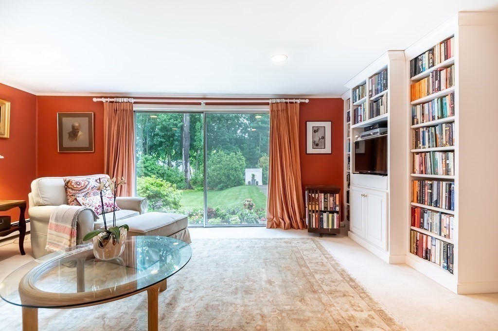 16 Hidden Road Andover, MA 01810 - Photo 16 of 42 a living room with furniture and a floor to ceiling window