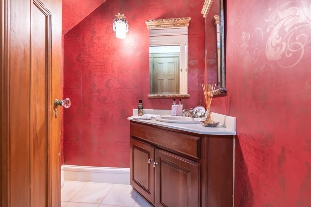 16 Hidden Road Andover, MA 01810 - Photo 17 of 42 a bathroom with a granite countertop sink and a mirror