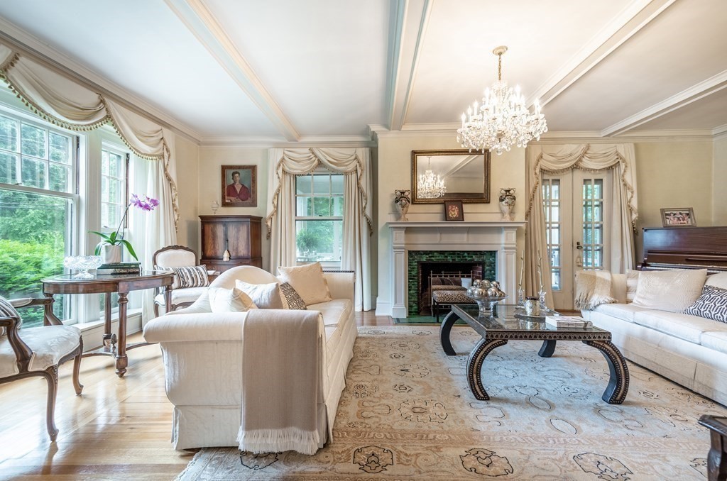 16 Hidden Road Andover, MA 01810 - Photo 6 of 42 a living room with furniture a chandelier and a fireplace
