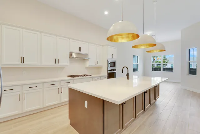 a kitchen with cabinets and wooden floor