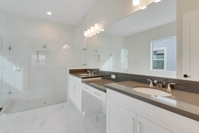 a bathroom with a sink double vanity and a mirror