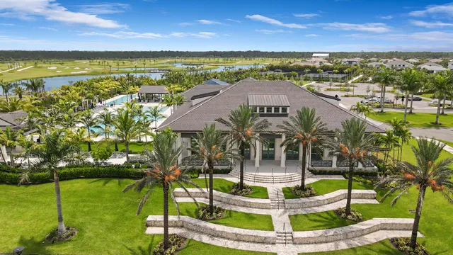 a view of a house with a yard and palm trees