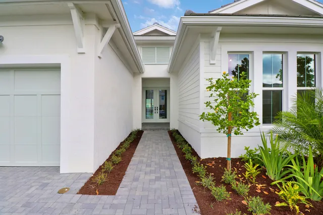 a view of a house with potted plants