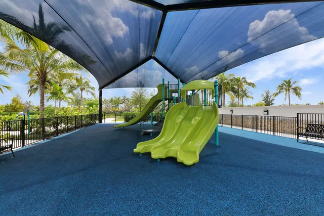 a living room with furniture and floor to ceiling windows