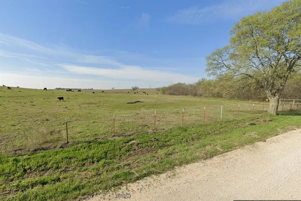 a view of a field with an ocean