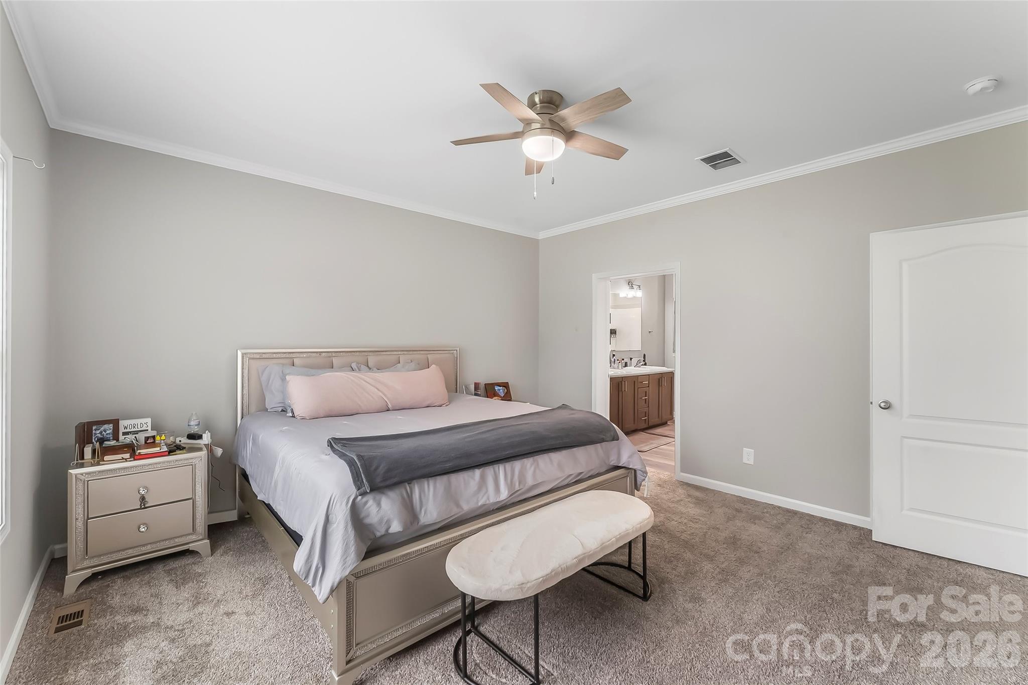 3511 Randleman Road Iron Station, NC 28080 - Photo 16 of 31 a bedroom with a bed and a chandelier