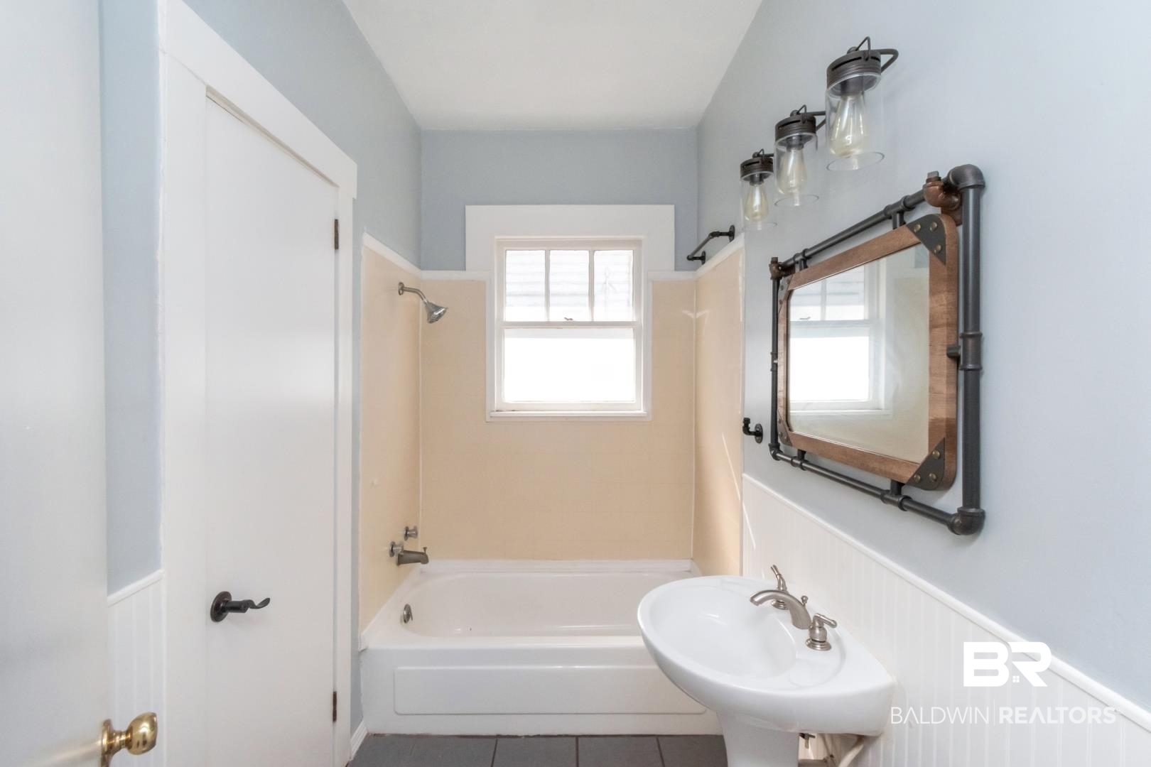 731 Jemison Street Mobile, AL 36606 - Photo 11 of 27 Full bath featuring a wainscoted wall, shower / bathtub combination, and tile patterned flooring