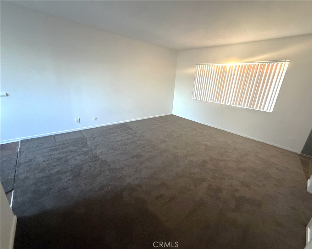 4015 137th Street, Unit 221 Hawthorne, CA 90250 - Photo 4 of 15 an empty room with windows