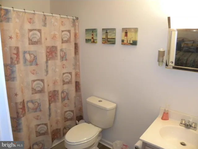 a white toilet sitting next to a bathroom sink