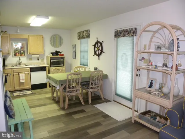 a dining room with furniture and view of kitchen