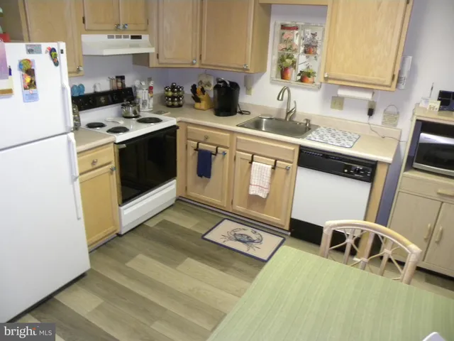 a kitchen with stainless steel appliances granite countertop a sink stove and white cabinets
