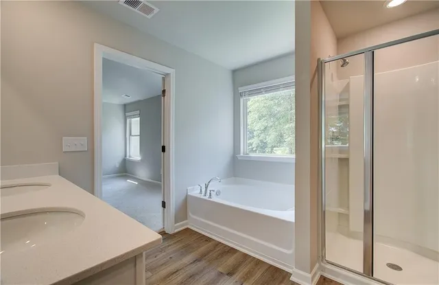a bathroom with a bathtub and a sink