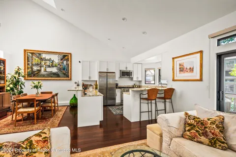 a living room with furniture and kitchen view