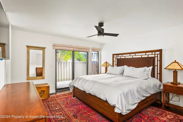 a bedroom with a large bed and a rug