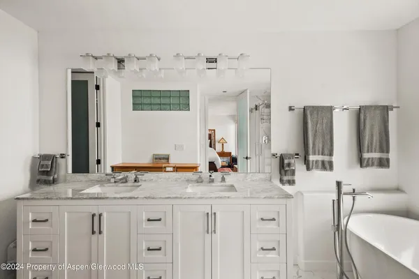 a bathroom with sinks granite countertop a sink and a mirror