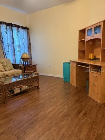 a bathroom with a granite countertop sink a toilet a mirror and shower