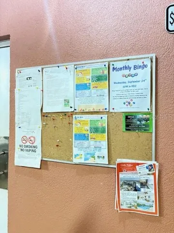 a dining room with furniture a large window and wooden floor
