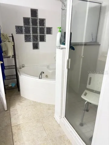 a bathroom with a bathtub and a shower