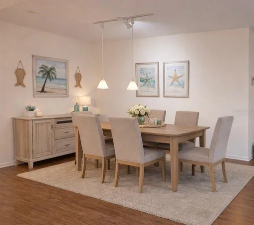 a view of a dining room with furniture and wooden floor