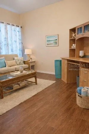 a living room with furniture and wooden floor