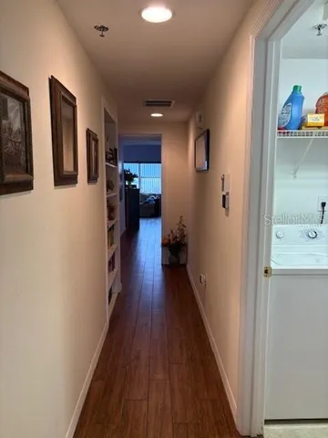 a living room with furniture a dining table and a wooden floor