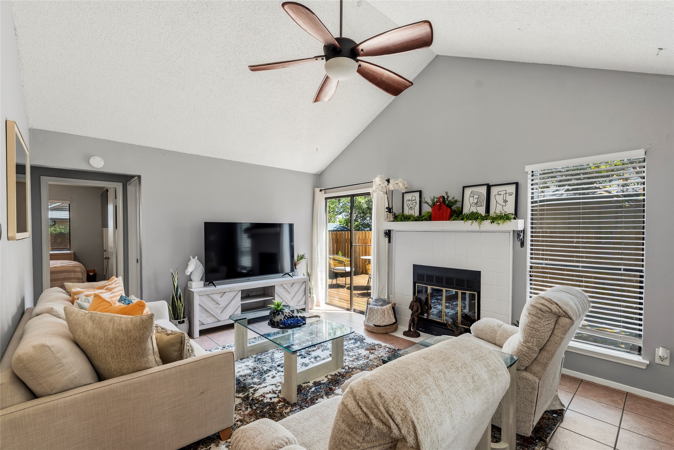 The entryway opens directly into a sunlit living room with high vaulted ceilings and tile flooring that run throughout all shared areas