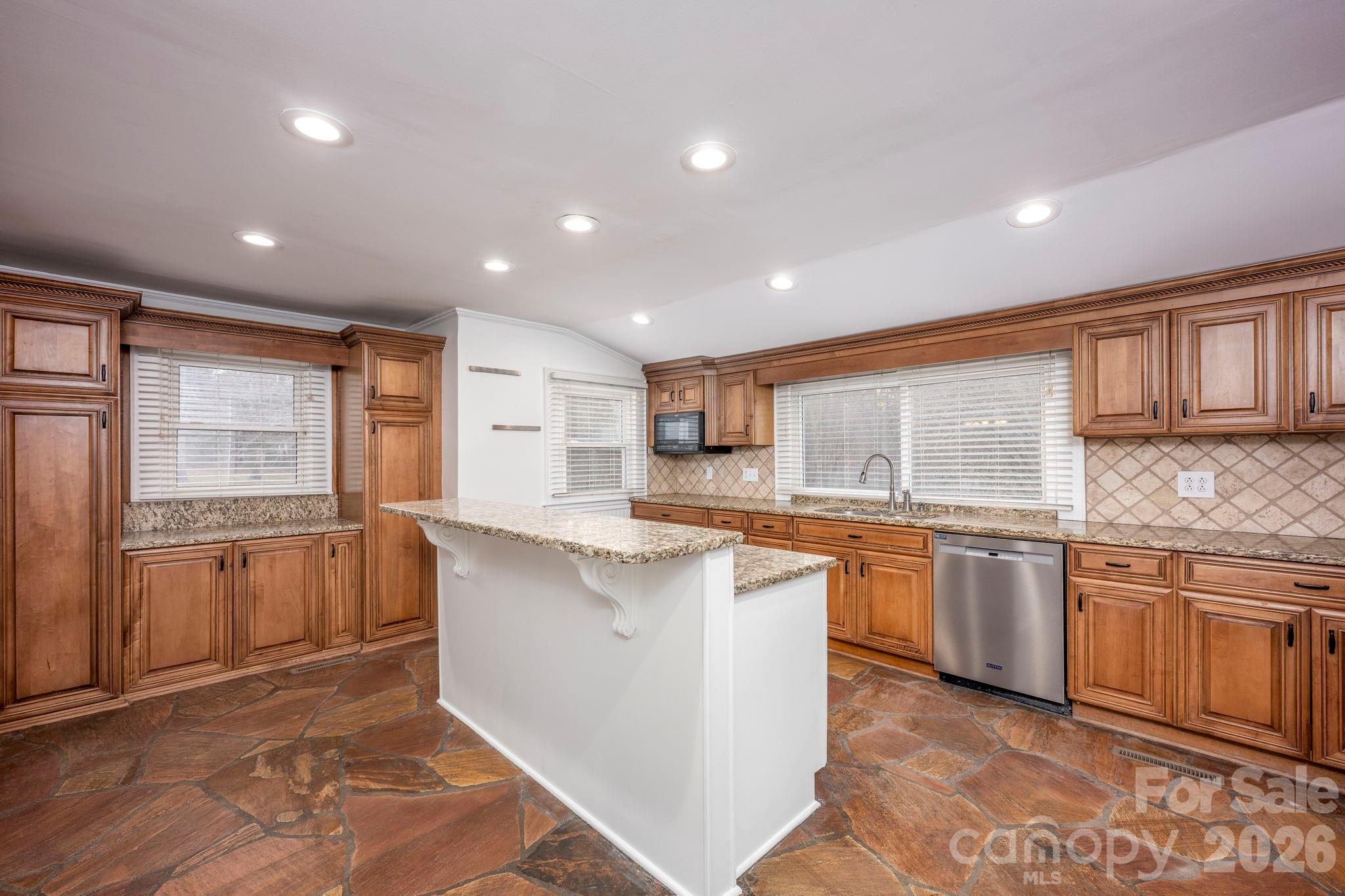 495 Chalk Maple Road China Grove, NC 28023 - Photo 25 of 48 a large kitchen with kitchen island granite countertop a stove a sink dishwasher and a refrigerator