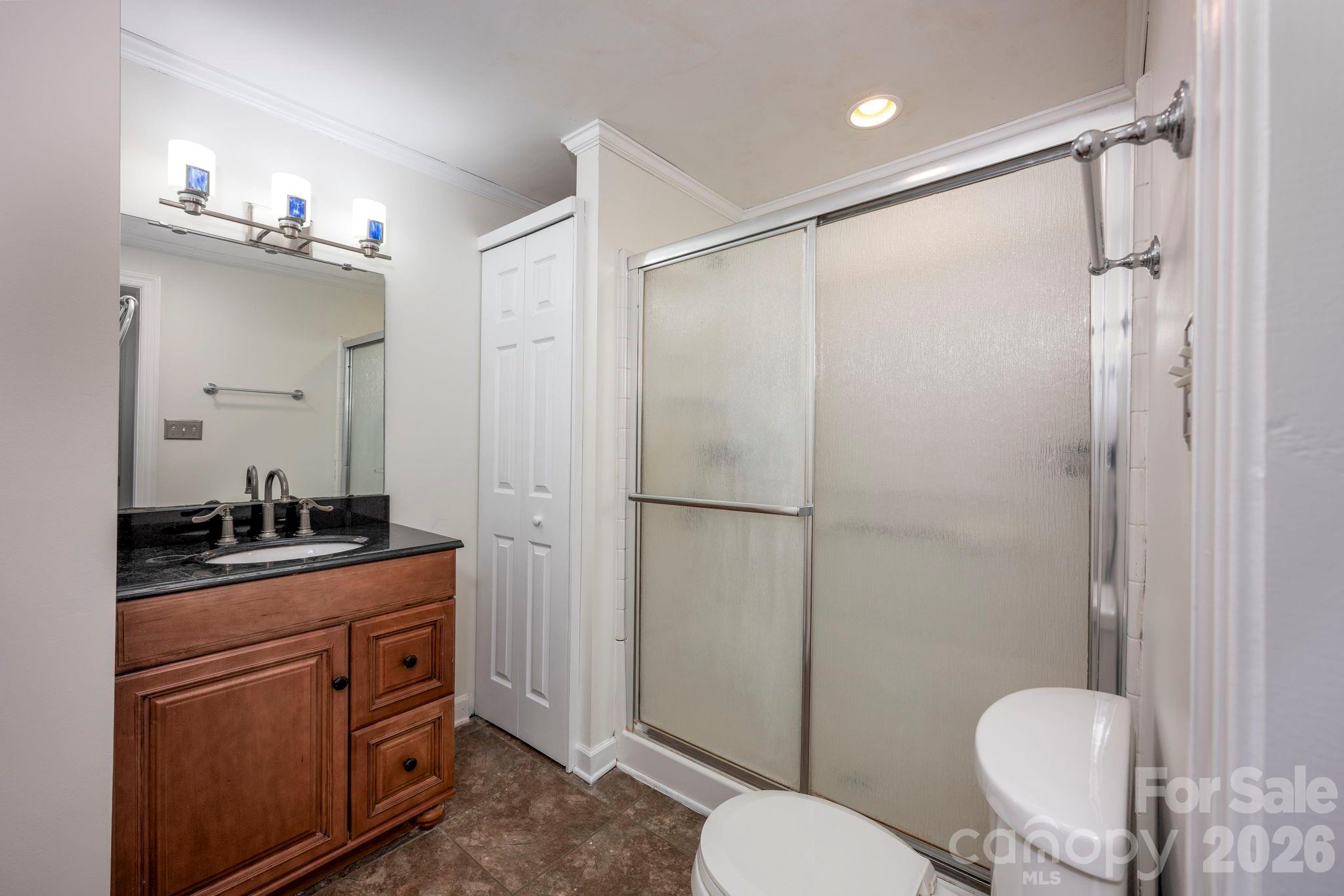 495 Chalk Maple Road China Grove, NC 28023 - Photo 30 of 48 a bathroom with a granite countertop sink toilet a mirror a vanity and shower