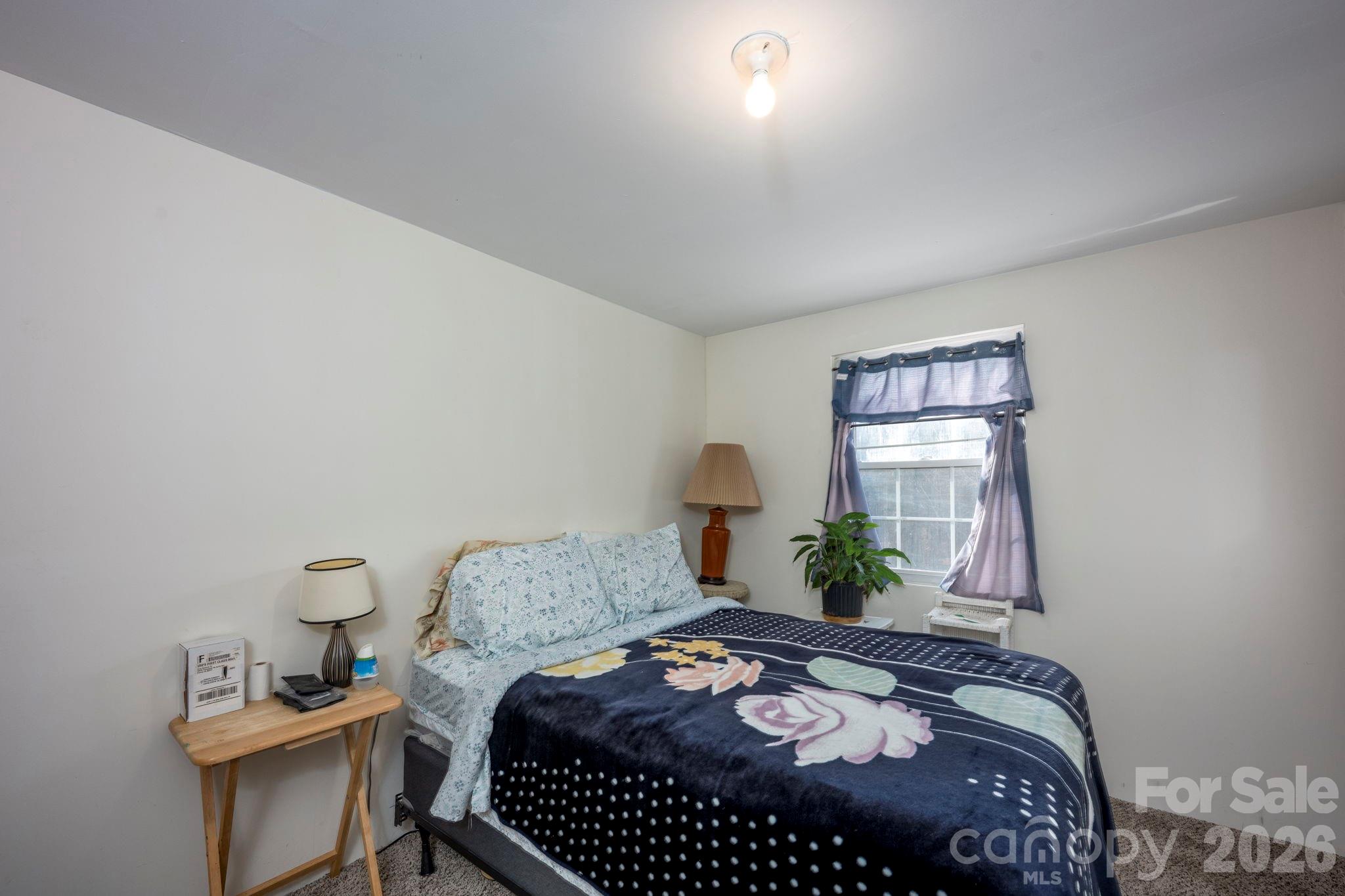 495 Chalk Maple Road China Grove, NC 28023 - Photo 46 of 48 a bedroom with a bed window and table
