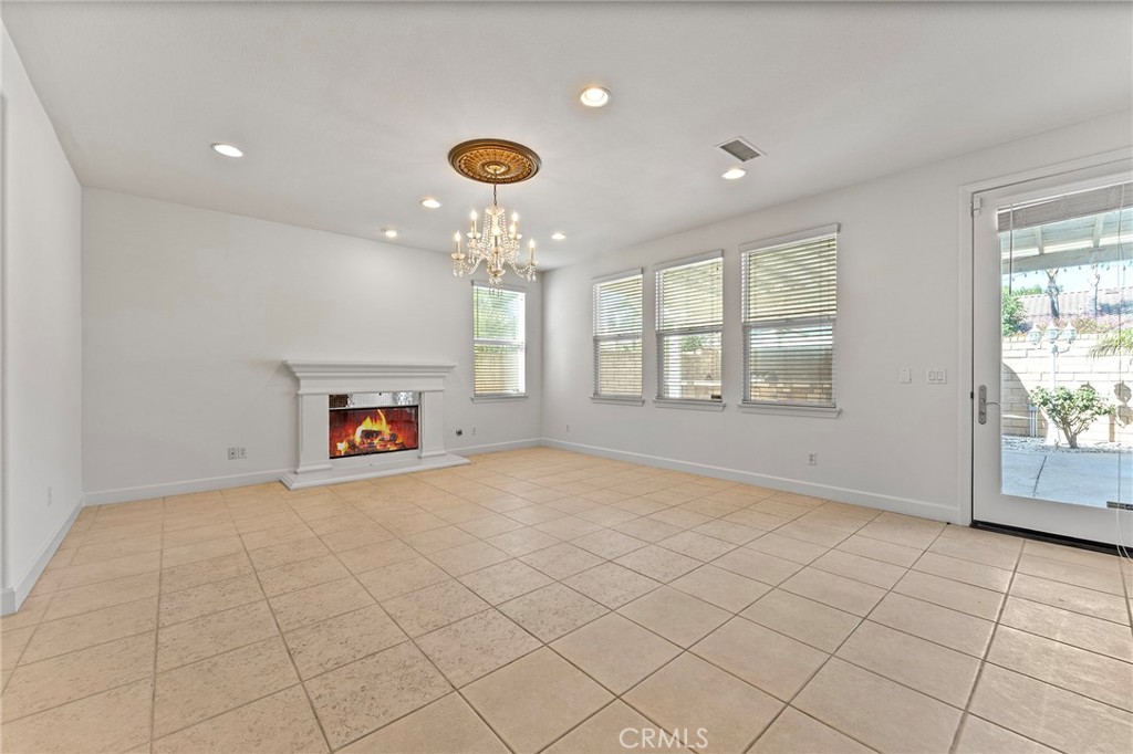 6360 Day Lily Court Rancho Cucamonga, CA 91737 - Photo 12 of 56 an empty room with windows and fireplace