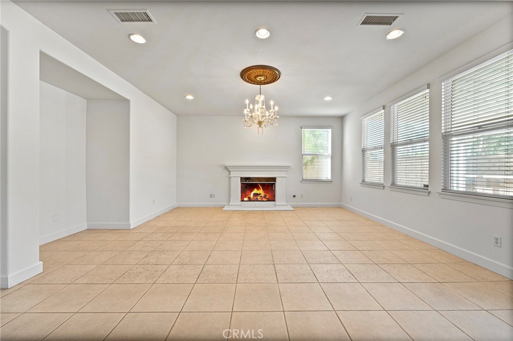 6360 Day Lily Court Rancho Cucamonga, CA 91737 - Photo 14 of 56 a view of an empty room with a window and fireplace