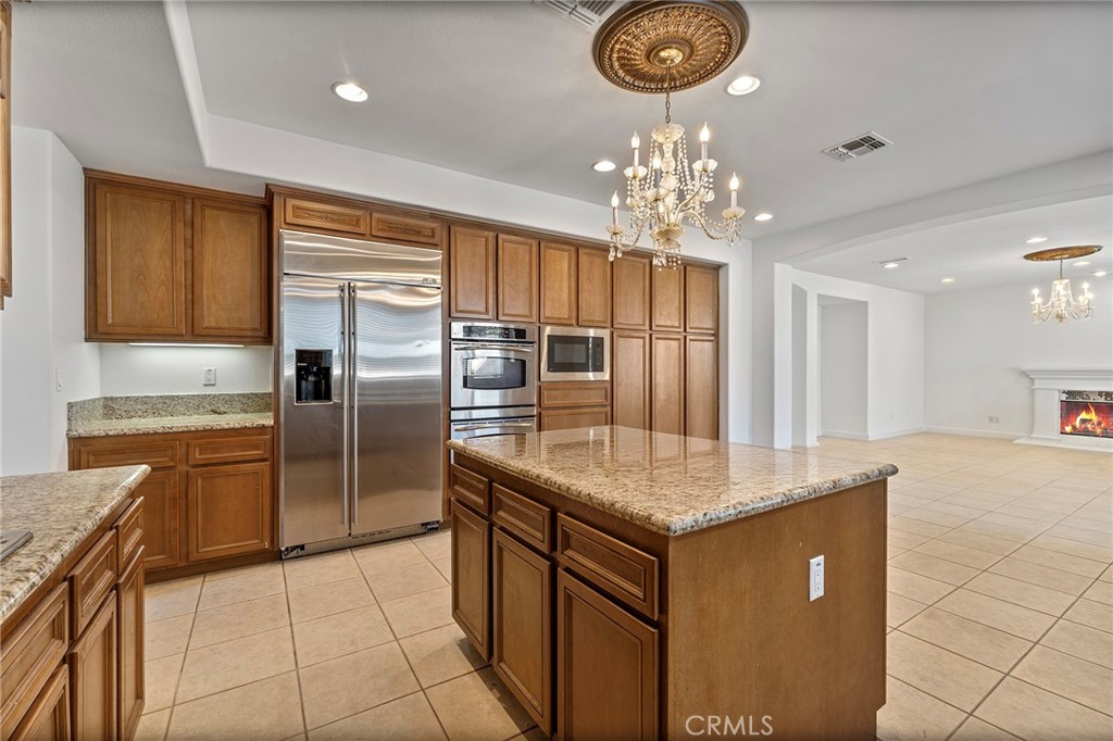 6360 Day Lily Court Rancho Cucamonga, CA 91737 - Photo 20 of 56 a kitchen with stainless steel appliances granite countertop a sink dishwasher and a refrigerator