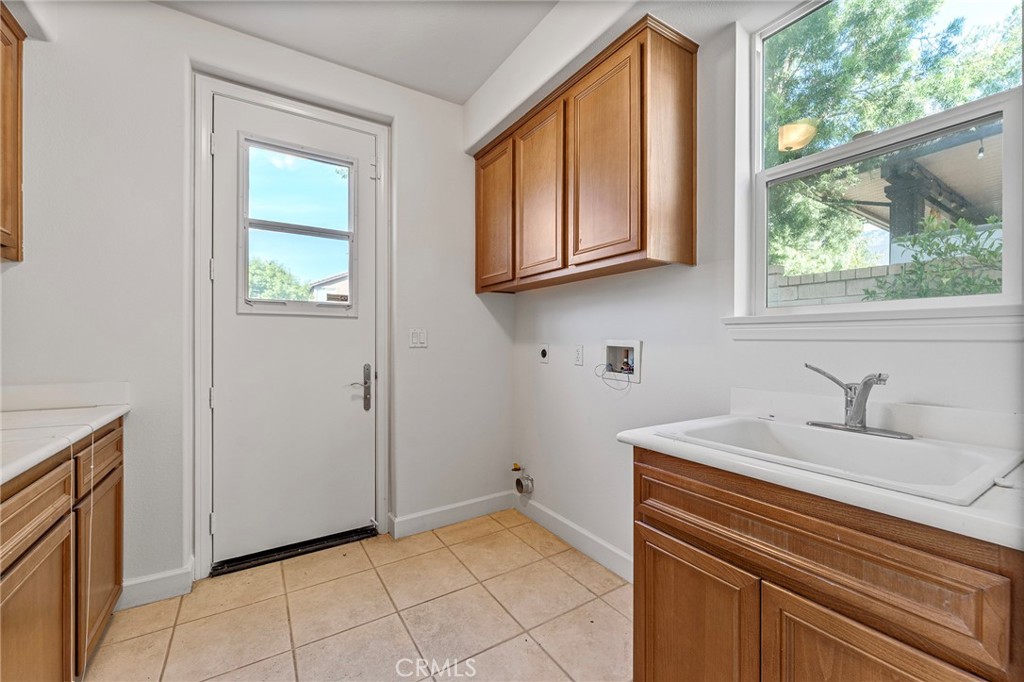 6360 Day Lily Court Rancho Cucamonga, CA 91737 - Photo 22 of 56 a kitchen with a sink cabinets and a window