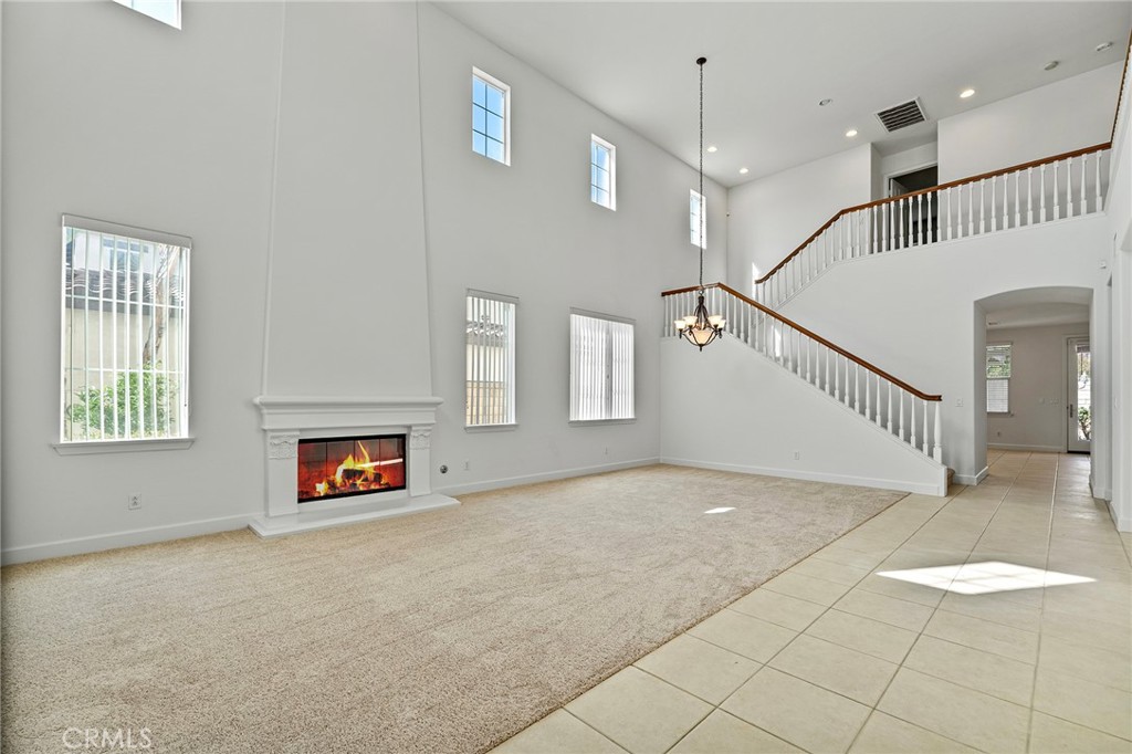 6360 Day Lily Court Rancho Cucamonga, CA 91737 - Photo 6 of 56 a view of main area with a fireplace and a chandelier